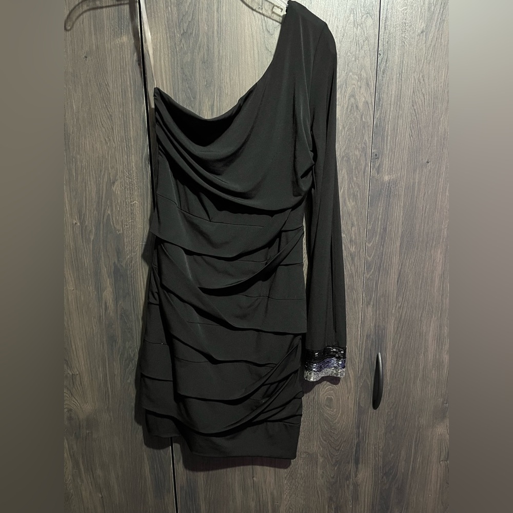 Short, black dress, off the shoulder with beaded design around the wrist